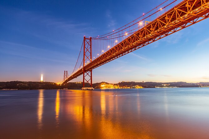 Amazing Tour on Sailing Boat - The 25th of April Bridge at sunset