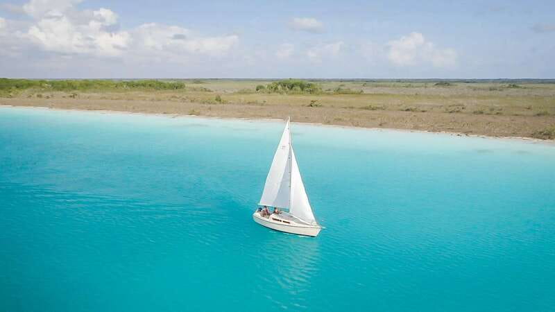 Bacalar: Group Sailing Trip with Swimming and Drinks - Passing Cenote Esmeralda and settling into the water