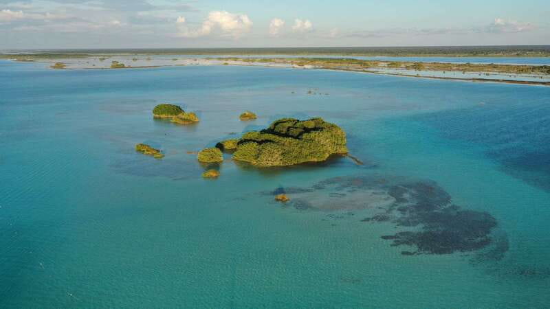 Bacalar: Group Sailing Trip with Swimming and Drinks - Cenote Negro and the lagoon’s darker blue