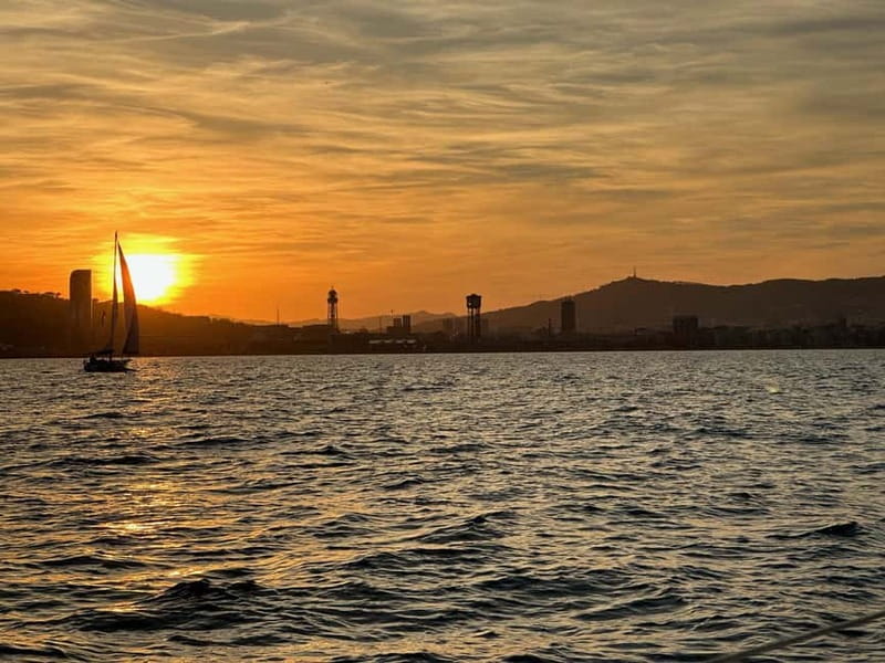 Barcelona: Sunset Sailboat Cruise with Open Bar and Snacks - Timing the sunset over Barcelona