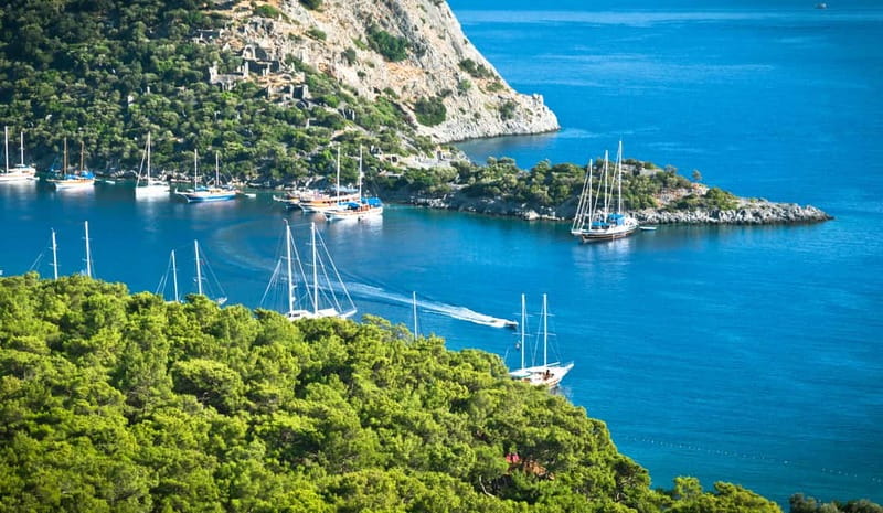 Fethiye: Island Sailing Trip with Lunch and Hotel Pickup - Dockyard Island, calm water, and old ruins