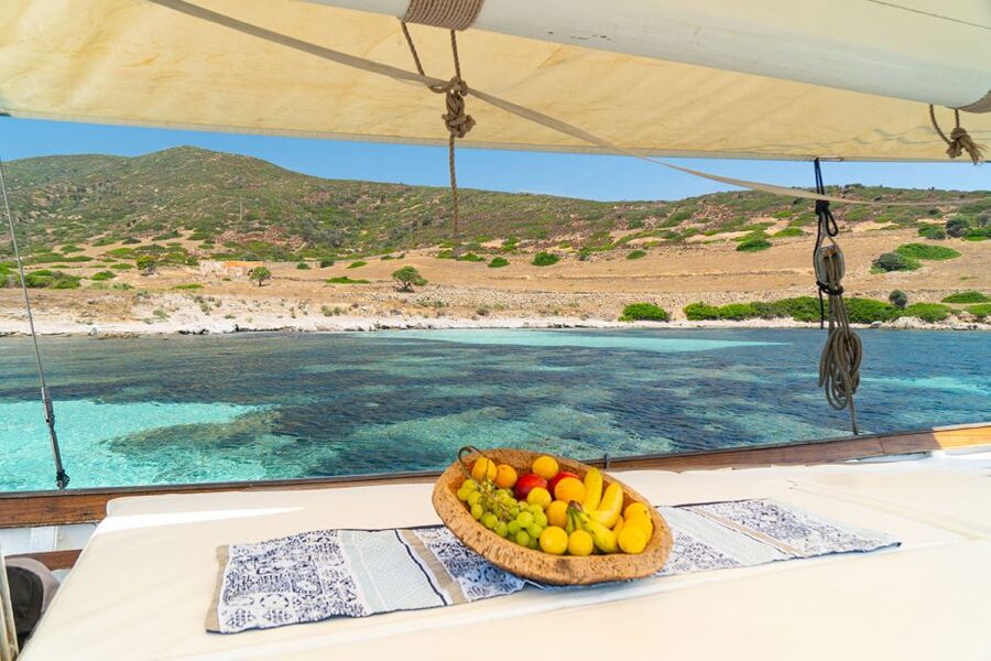 From Stintino: Asinara Vintage Sailing Boat Tour with Lunch - Cala del Bianco ends the swimming day
