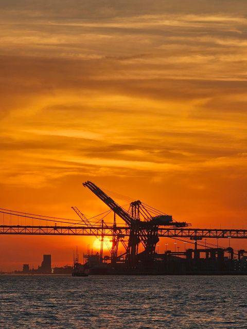 Lisbon: Private Sailboat Tour on the Tagus at Sunset - Under the bridge with Cristo Rei across the water