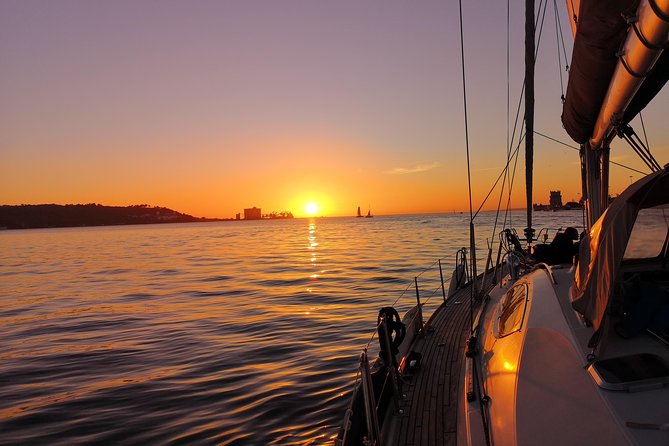 Lisbon Sunset Sailing Tour on Luxury Sailing Yacht with 2 Drinks - Wine, beer, cheese, and the sunset