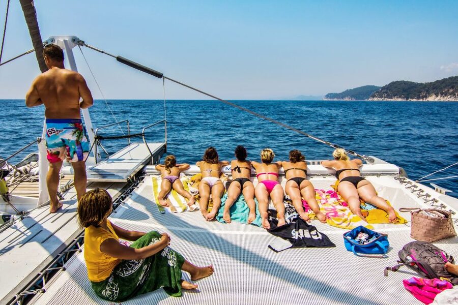 Lloret de Mar: Catamaran Sailing Cruise with BBQ and Drinks - Music, dancing, and the return to Lloret