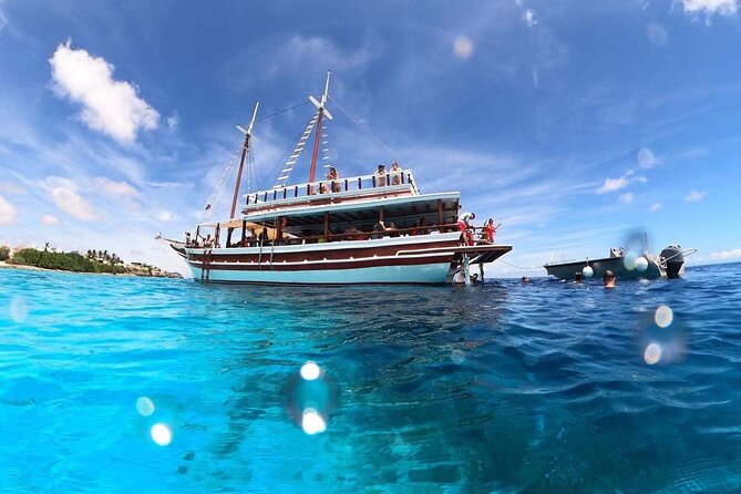 Luxury snorkel trip on a spacious wooden schooner and local lunch - The rope swing and music bring a playful finish