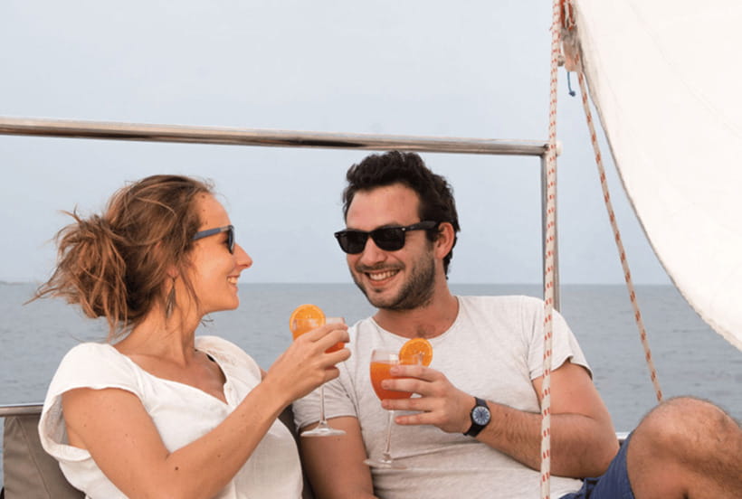 Mirissa: Sunset Catamaran Sailing Boat Tour with Dinner - A swim and paddleboard stop in clear water
