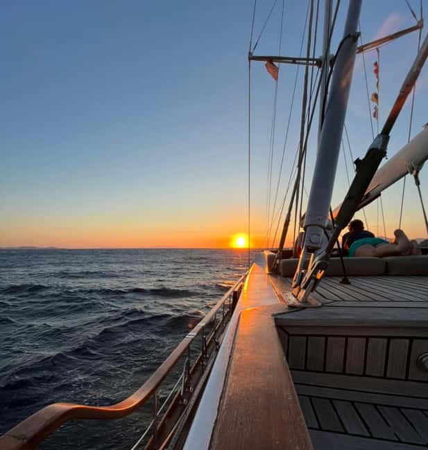 Mykonos: Sunset Sail Cruise to Rhenia, Beach Hopping, Dinner - Leaving Mykonos and passing the famous beaches
