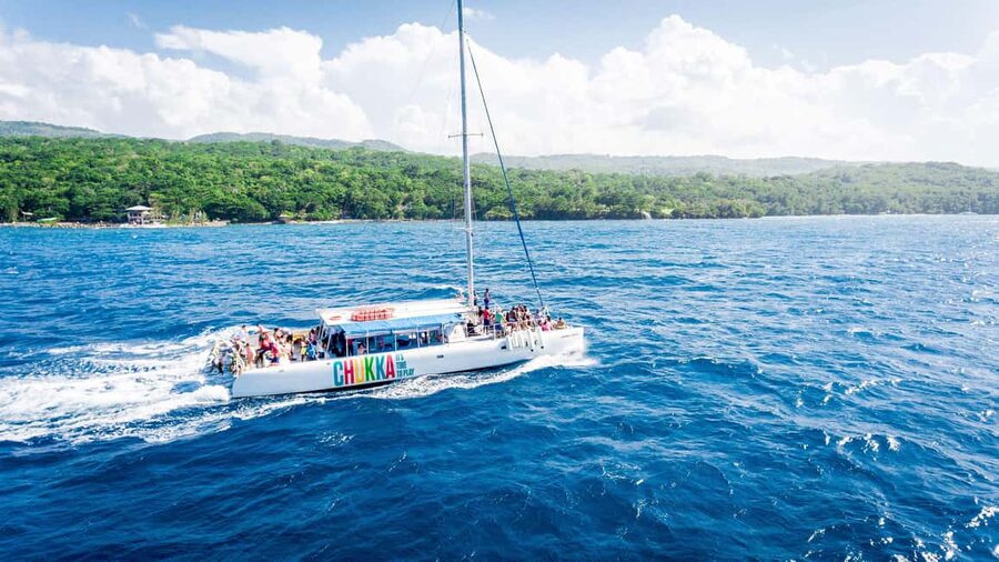 Ocho Rios: Catamaran Sail & Snorkel + Dunn's River Climb - Sailing with reggae music and open sea views