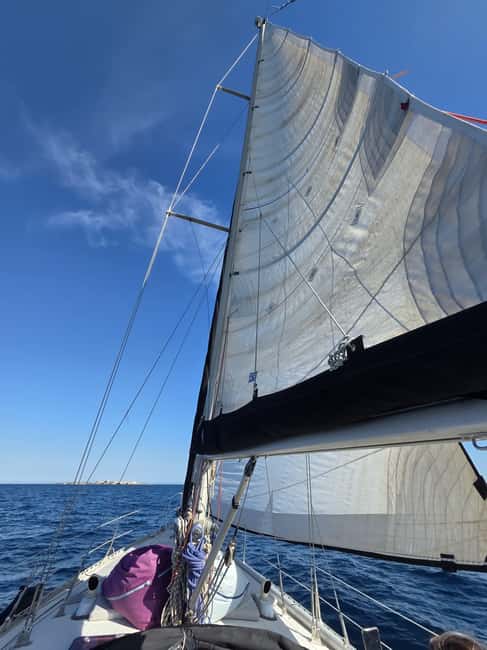 Santa Pola: Sail to Tabarca, snorkel, and enjoy sunset with a tasting - Local snacks, wine, and a relaxed deck atmosphere