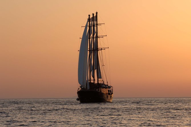 Santorini Caldera Sunset Sailing Cruise with Dinner and Wine - Sunset from the water near Oia