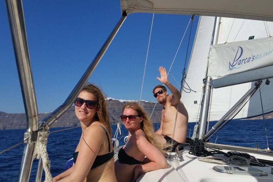 Santorini Caldera: Sunset Sailing Cruise with Meal - The lighthouse and sailing inside the caldera