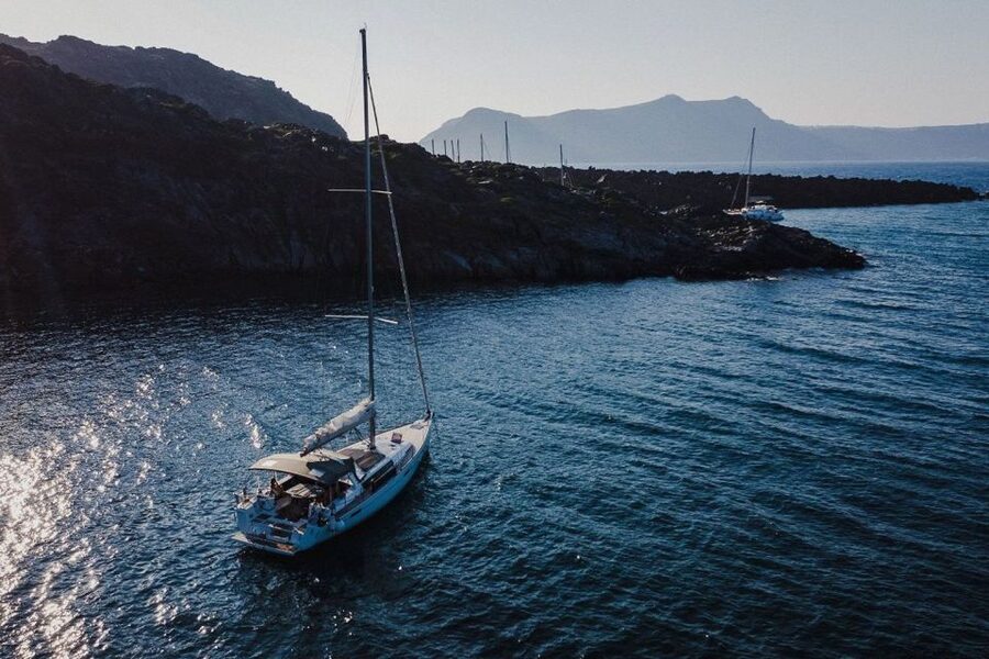 Santorini: Private Caldera Sailing Trip with Open Bar & Meal - Entering the caldera below the Venetian Lighthouse