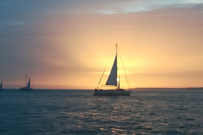 Small Group Sailboat Sunset Tour in Lisbon with a Drink - Passing beneath Lisbon’s famous bridge